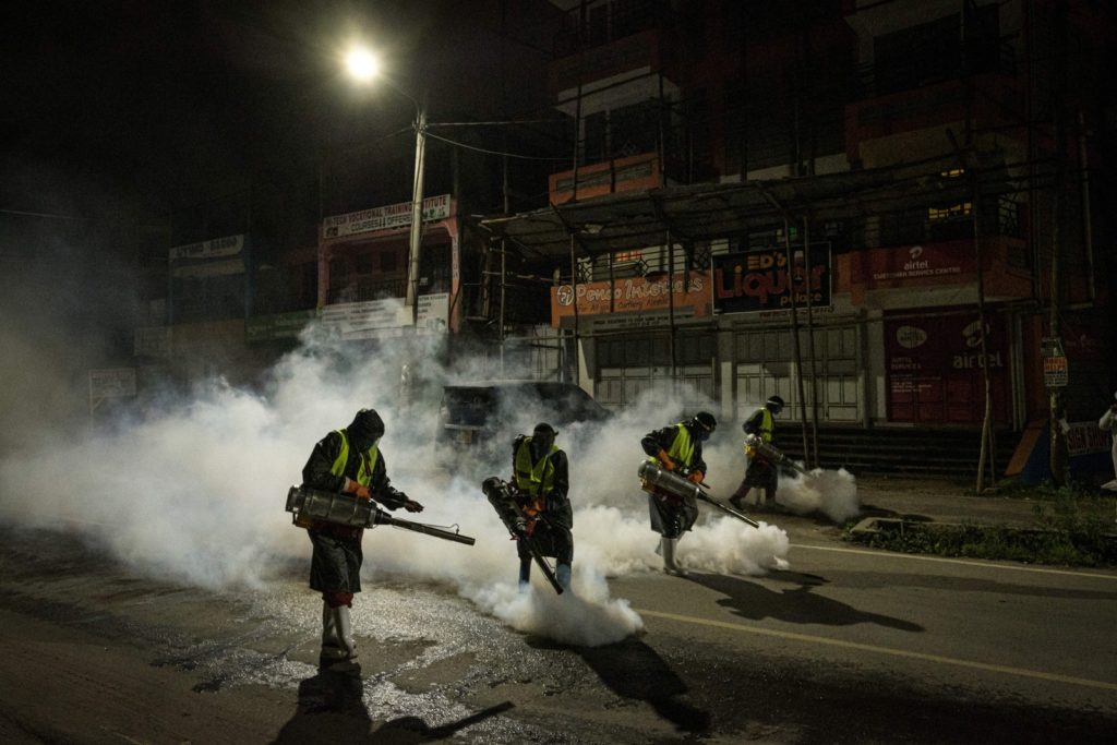 In Nairobi, Kenya, volunteers from Sonko Rescue Team, an NGO privately funded by Nairobi Governor Mike Sonko, fumigate a street on April 6 to curb the spread of COVID-19.Photo: Yasuyoshi Chiba / AFP via Getty Images