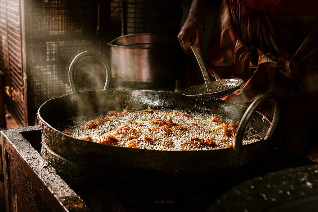 person cooking deep fried chicken close-up photo